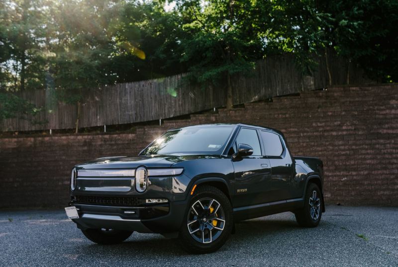 Rally Armor 22-25 Rivian R1T Black UR Mud Flap w/Tangerine Scream Logo